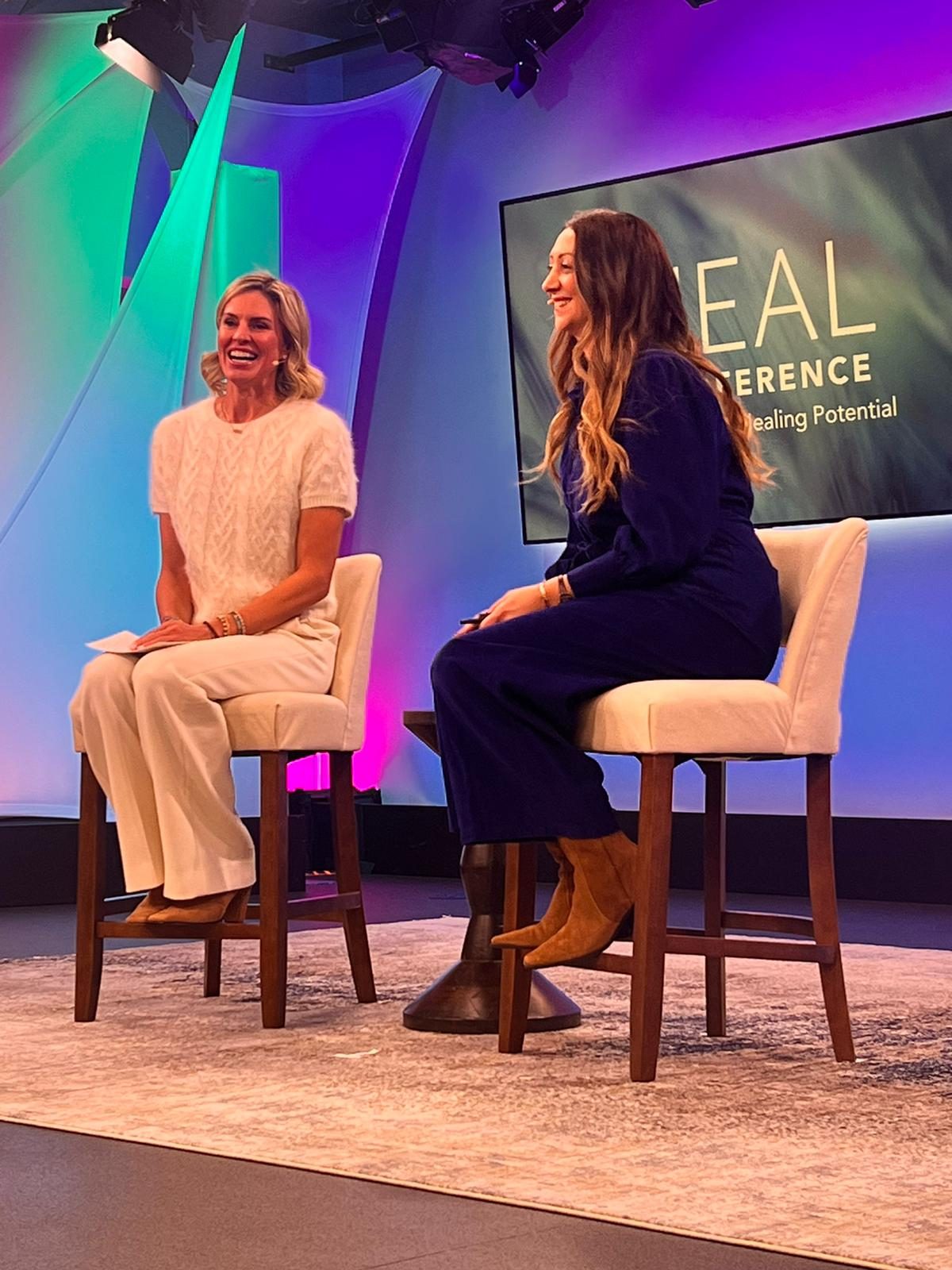 Lauren and Kelly Noonan Gores on stage together at the Heal conference