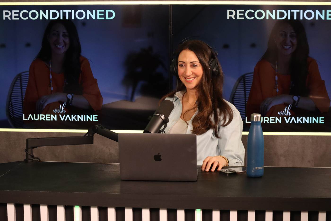 Lauren recording Reconditioned at her podcast desk
