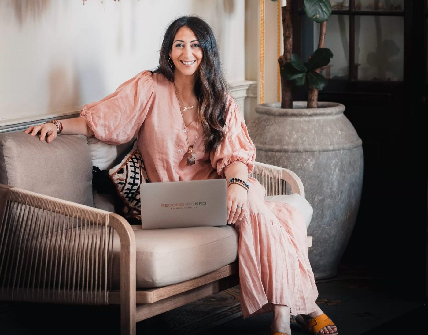 Lauren smiling, working at her laptop