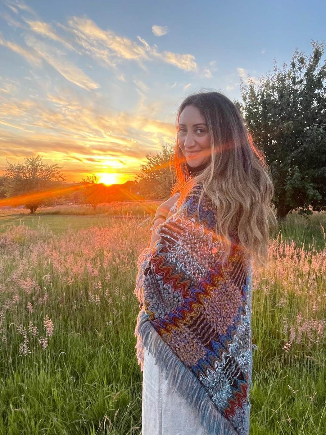 Lauren smiling at sunset with a shawl over her shoulders