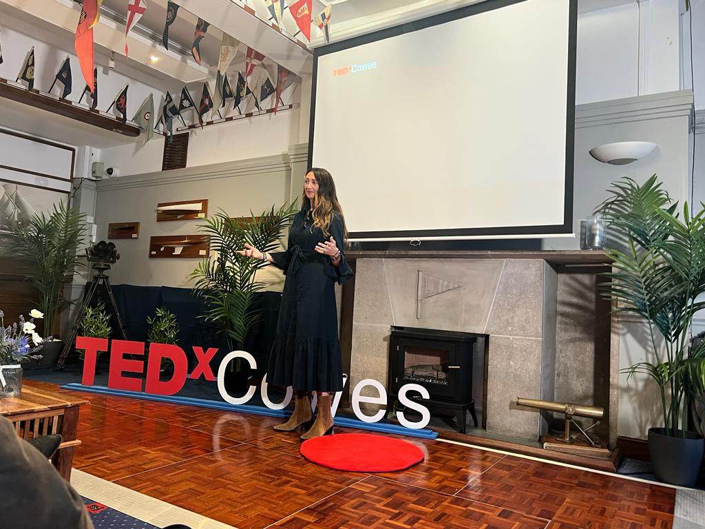Lauren speaking on the TEDx stage